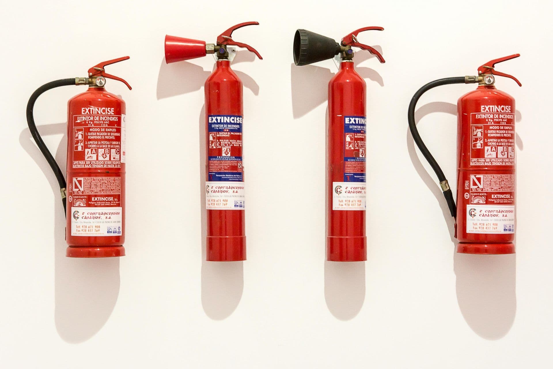 Fire extinguishers mounted on wall, inspected and certified in Texas